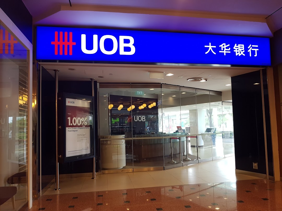 The illuminated UOB bank sign and glass entrance of the Jurong Point branch are visible.