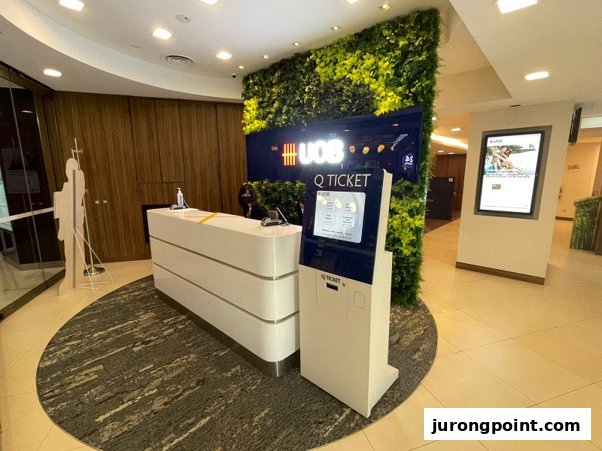 Modern interior of UOB Jurong Point branch with reception desk and Q-ticket system.