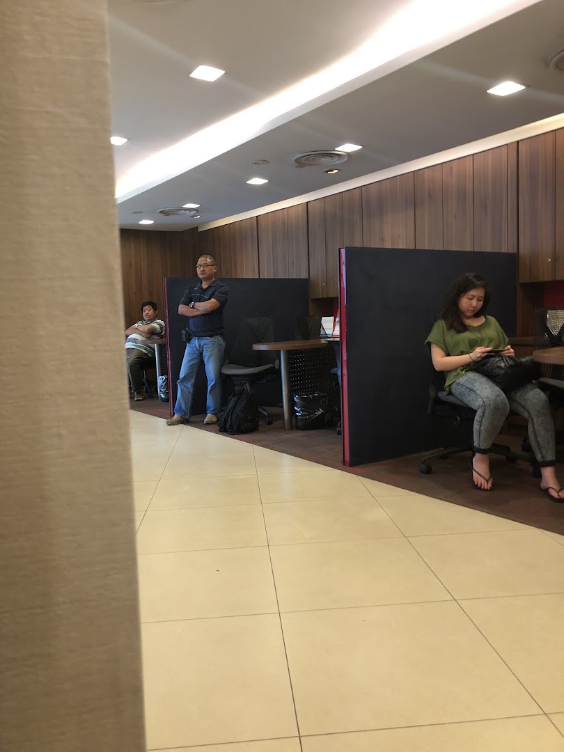 Customers and staff inside the UOB Jurong Point branch, featuring service counters and waiting areas.