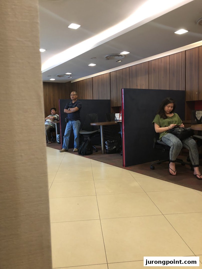 Customers and staff inside the UOB Jurong Point branch, featuring service counters and waiting areas.