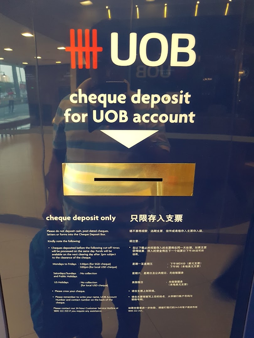 A UOB bank branch entrance featuring a cheque deposit box with instructions.