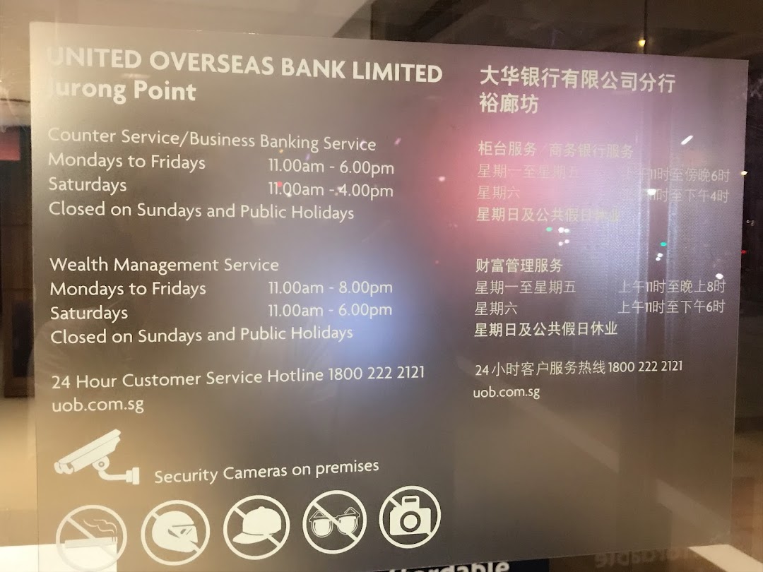 UOB Jurong Point branch operating hours and service details displayed on a glass panel.