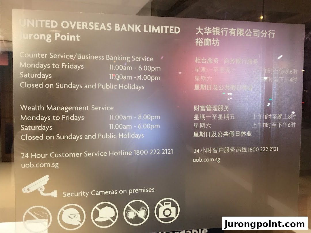 UOB Jurong Point branch operating hours and service details displayed on a glass panel.