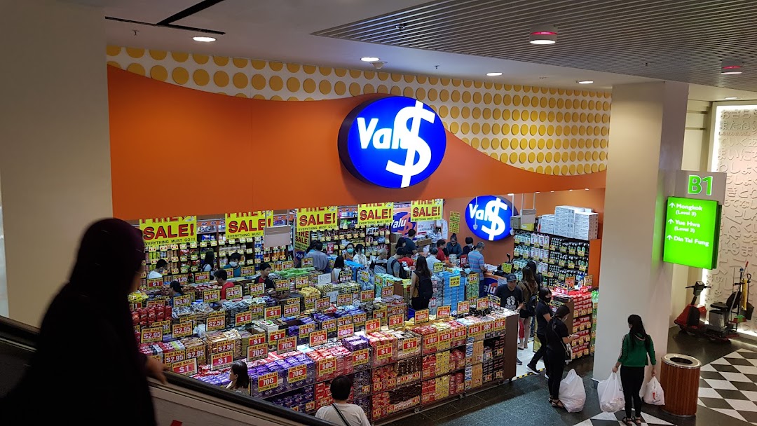 The vibrant orange entrance of Valu discount store, showcasing numerous products and customers inside.
