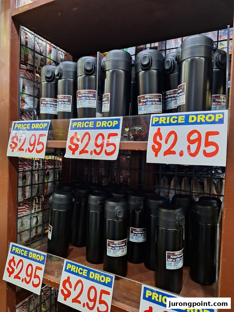 Shelves display black thermal bottles on sale for $2.95, designed to keep beverages hot or cold.