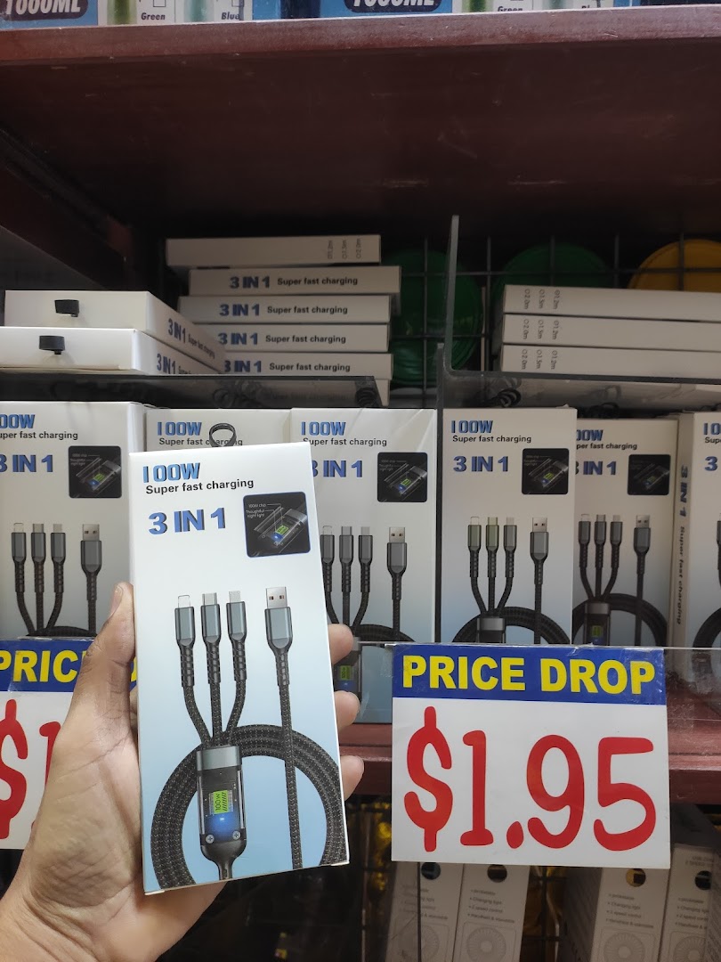 A hand holds a 3-in-1 super fast charging cable box, with more products and a '$1.95 PRICE DROP' sign on shelves.