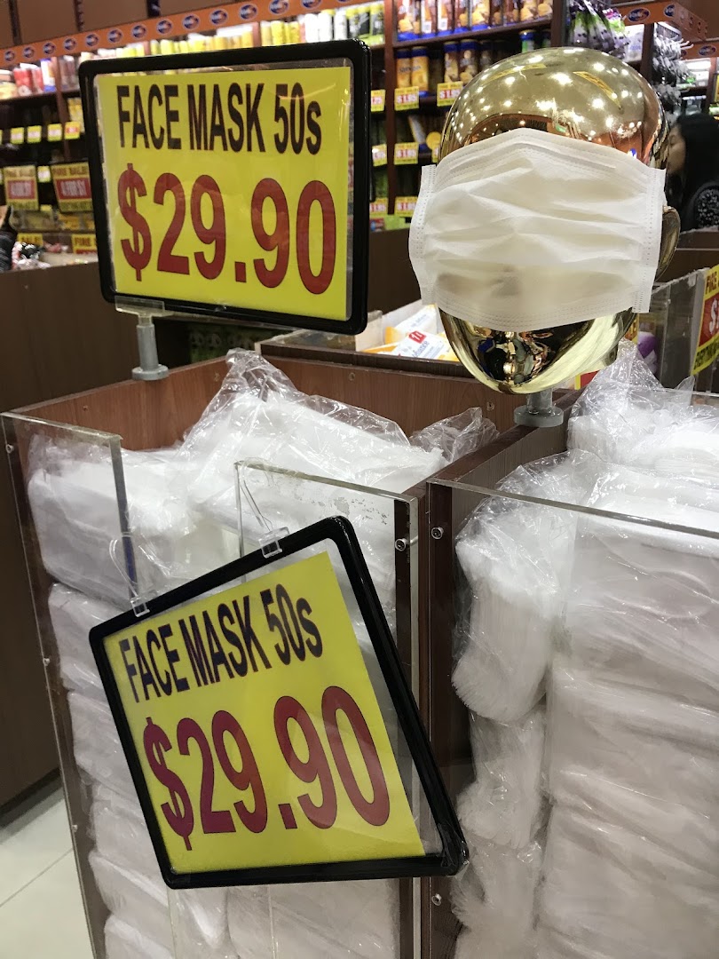 A display of face masks for sale at Valu, featuring price signs and a mannequin head.