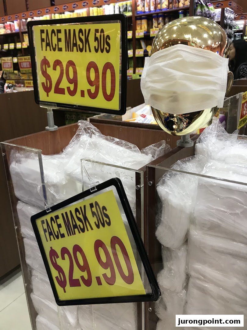 A display of face masks for sale at Valu, featuring price signs and a mannequin head.