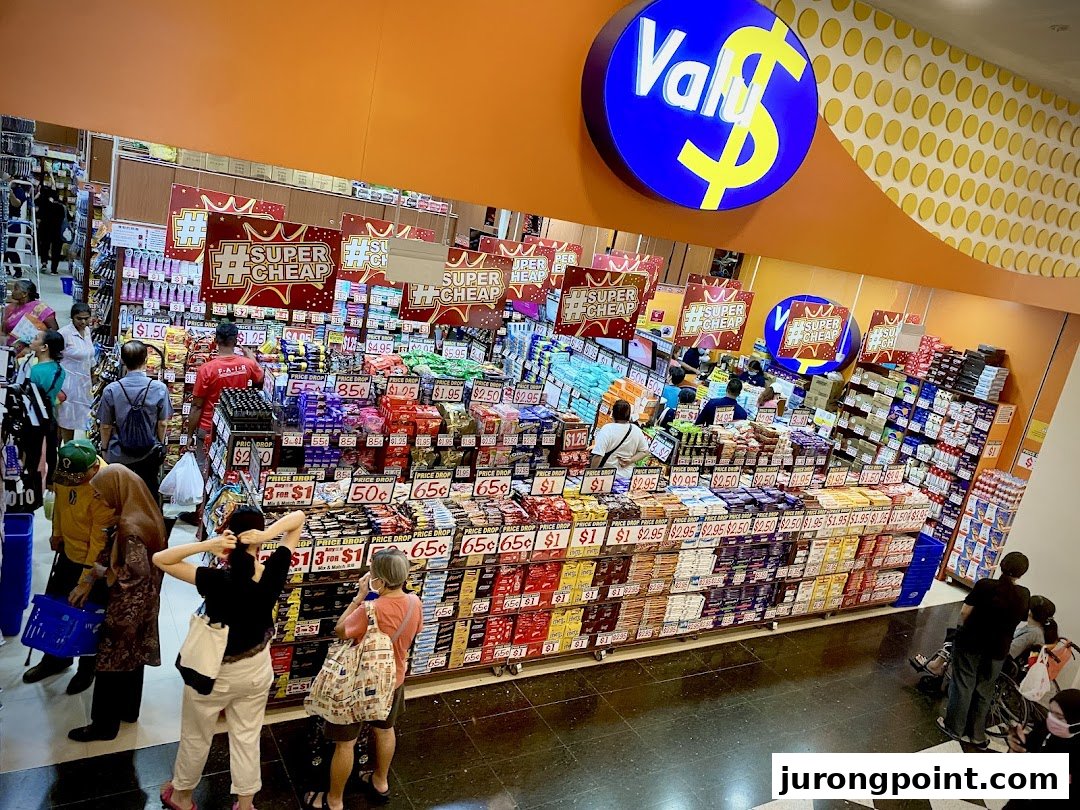 A bustling interior view of Valu, a discount store, showcasing a wide array of products and shoppers.