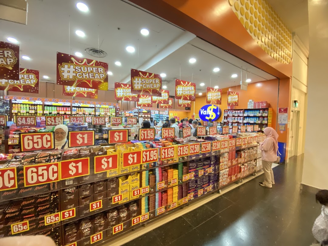 Interior view of Valu store showcasing aisles of discounted snacks and goods with customers browsing.