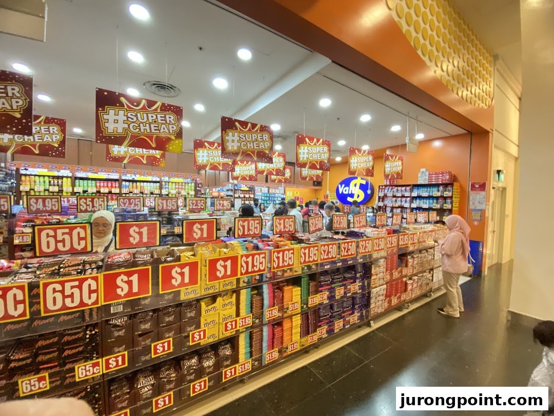 Interior view of Valu store showcasing aisles of discounted snacks and goods with customers browsing.