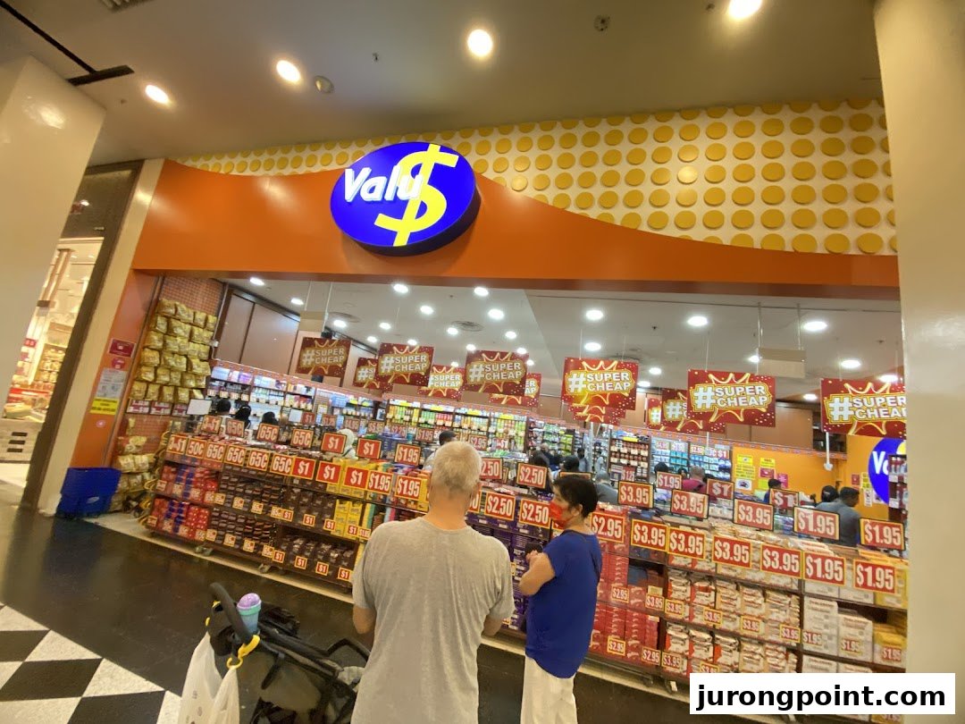 The vibrant storefront of Valu, a discount store, showcasing numerous products and prices.