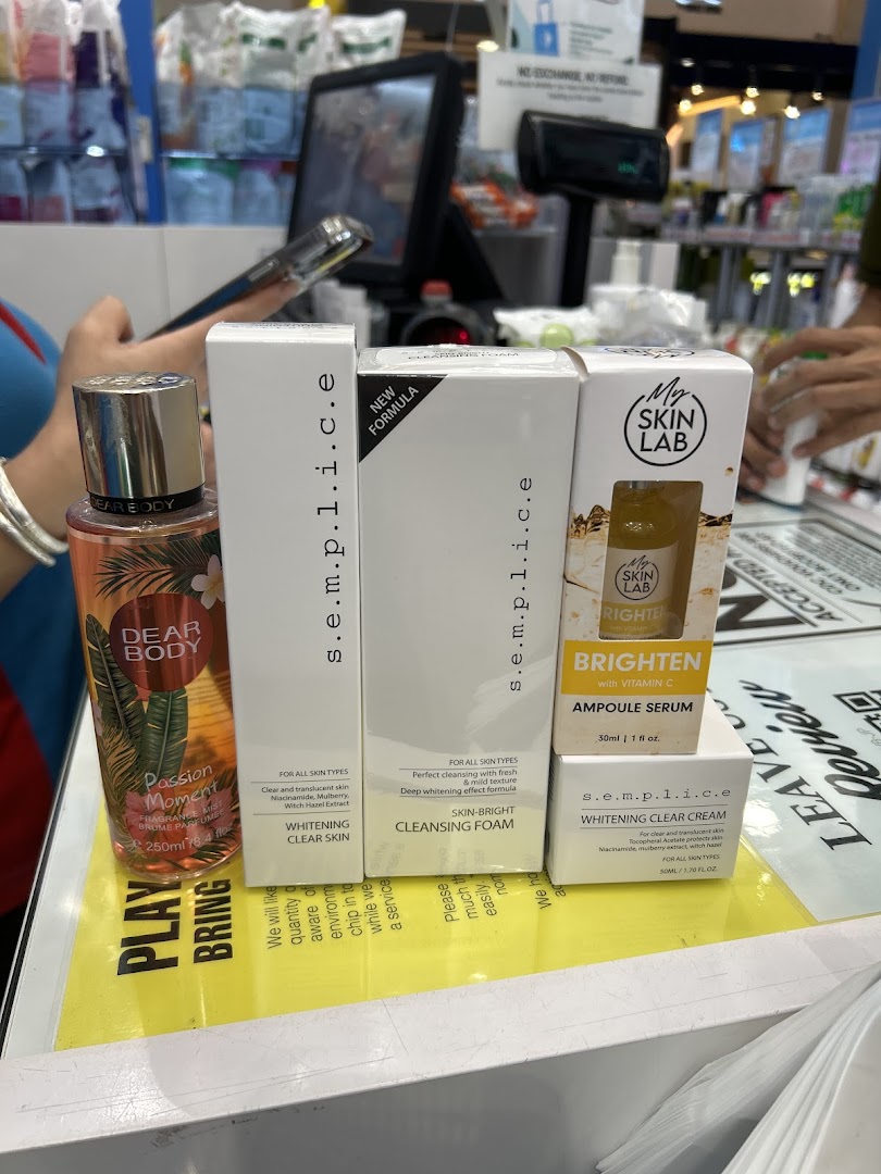 A display of various beauty and skincare products, including serums, cleansers, and body mist.