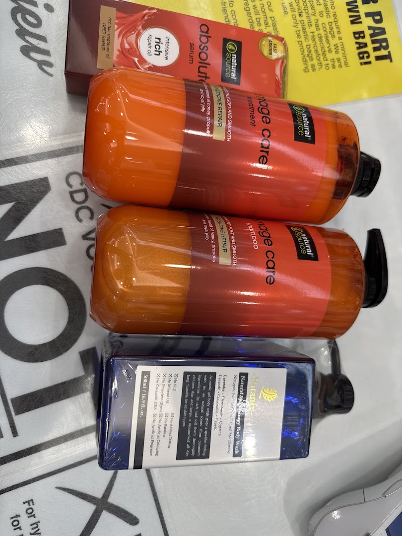 Close-up of various hair care and body wash products from Natural Source and Biotannic brands.