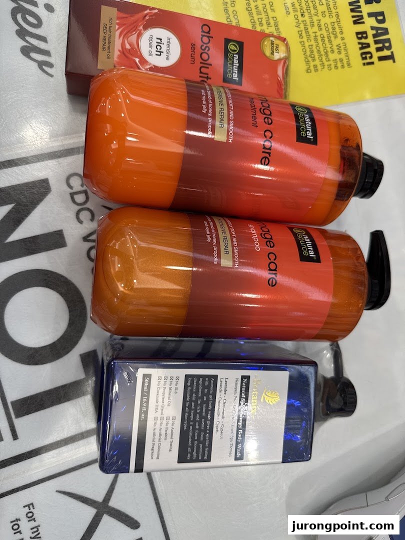 Close-up of various hair care and body wash products from Natural Source and Biotannic brands.