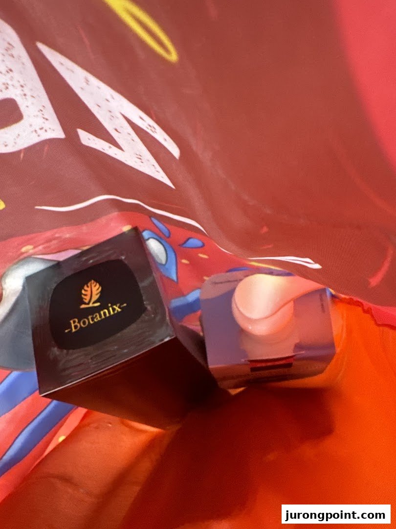 Two beauty products, including one labeled 'Botanix', inside a red shopping bag.