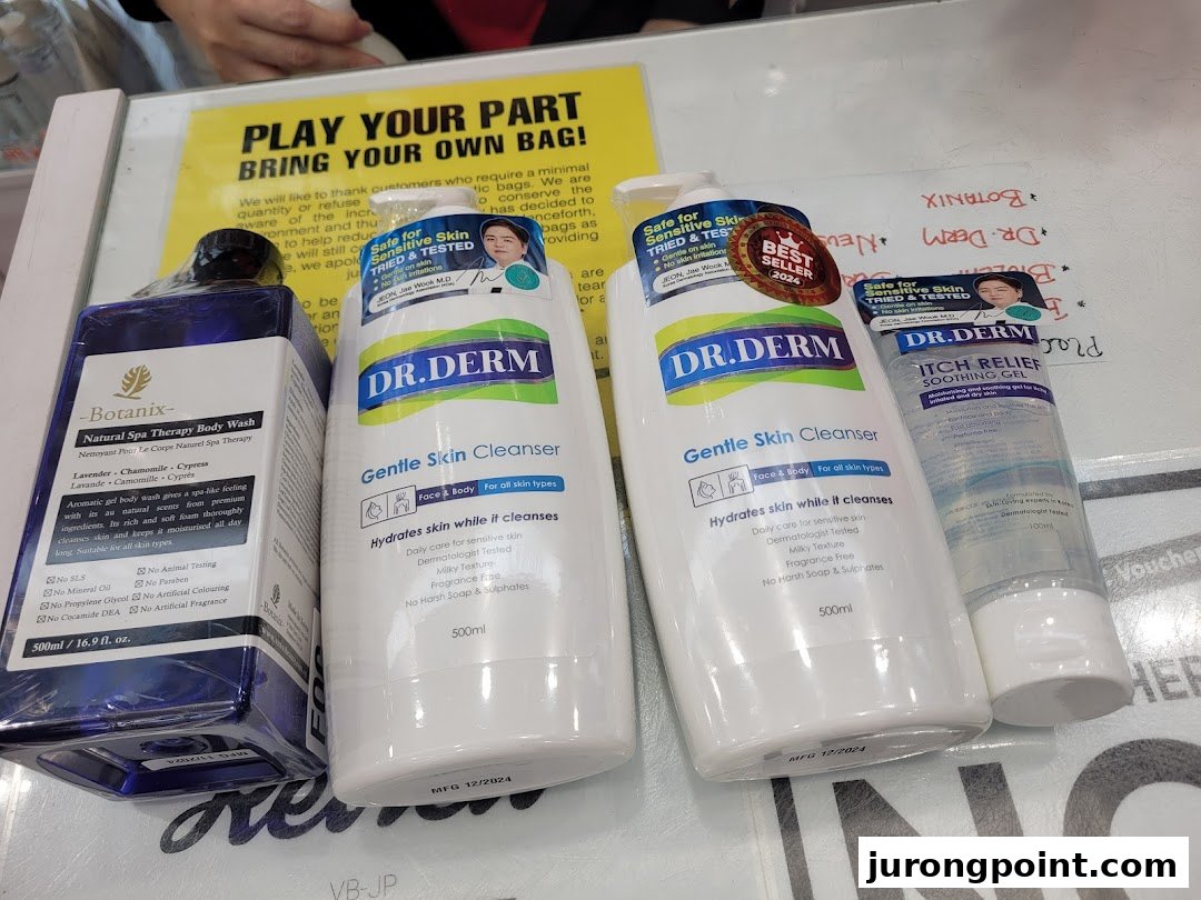 A close-up of various skincare and body care products, including cleansers and body wash, displayed on a counter.