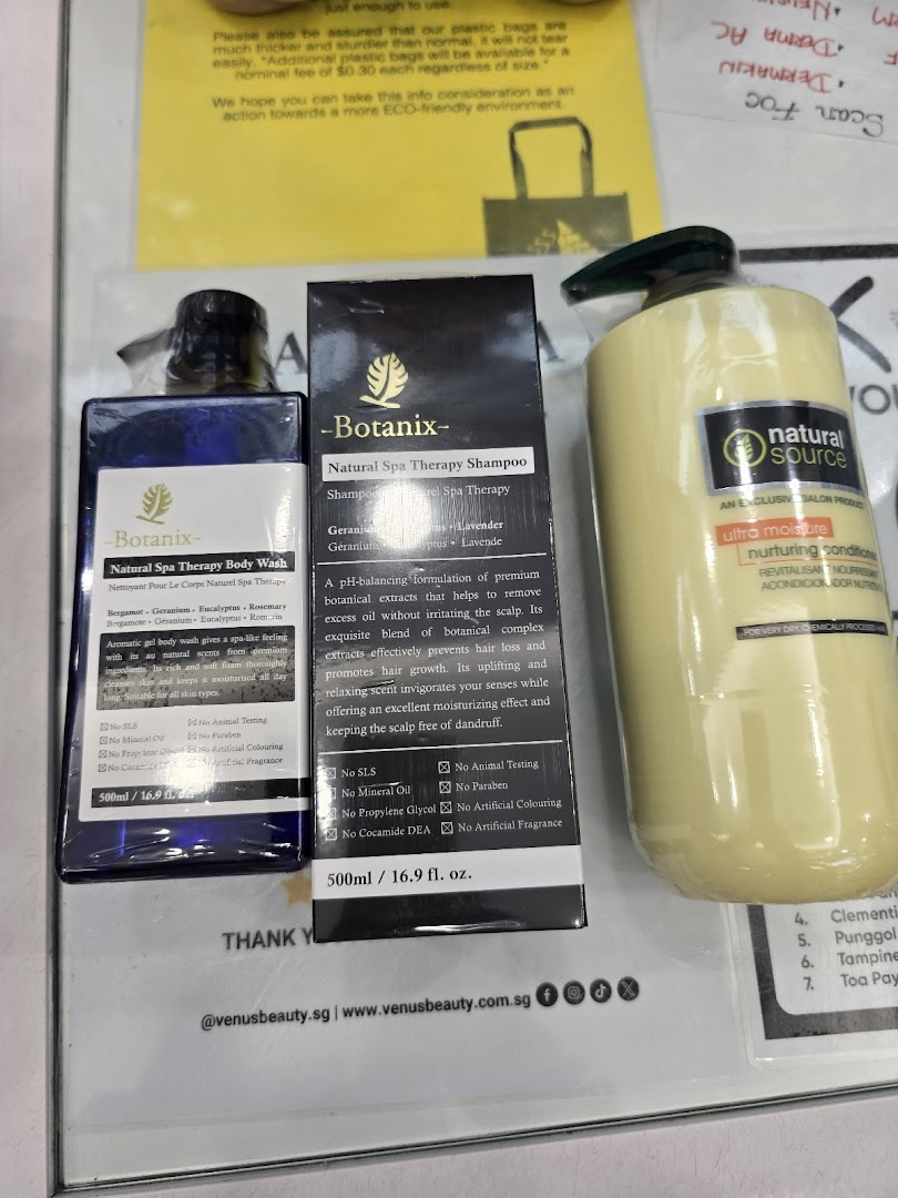 Close-up of Venus Beauty products, including Botanix body wash, shampoo, and Natural Source conditioner.