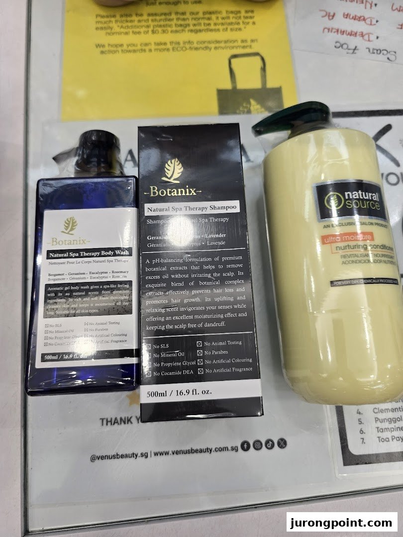 Close-up of Venus Beauty products, including Botanix body wash, shampoo, and Natural Source conditioner.