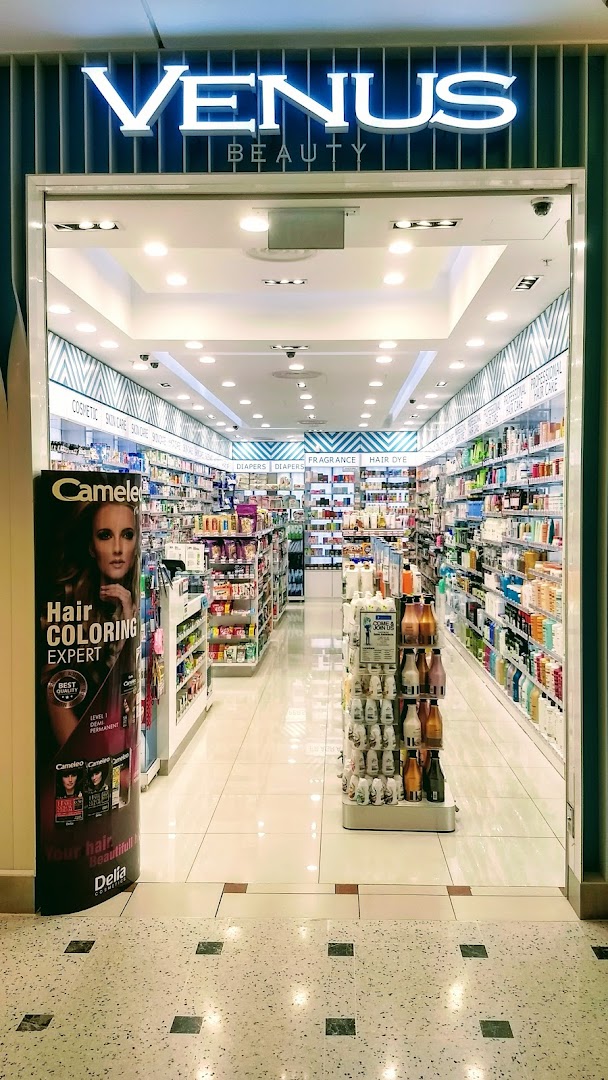 The brightly lit entrance of Venus Beauty, showcasing a wide range of cosmetic and hair care products.