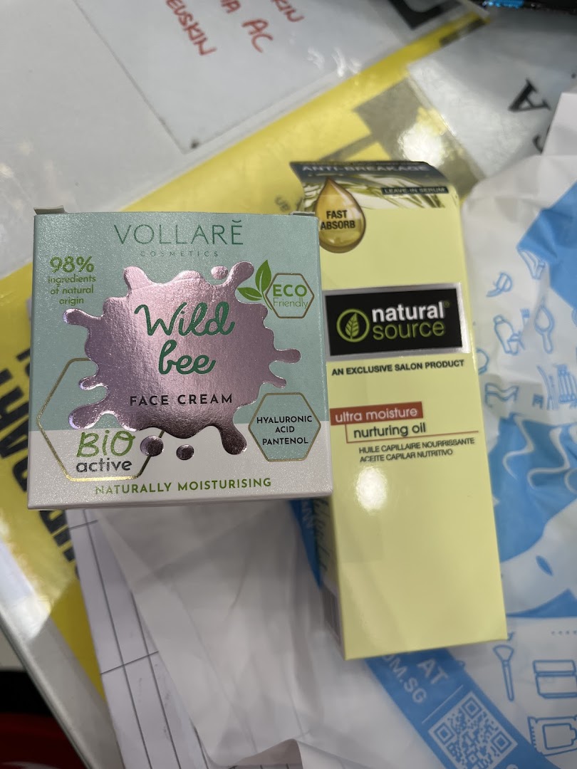Two beauty products, Vollare Wild Bee Face Cream and Natural Source Nurturing Oil, on a surface.