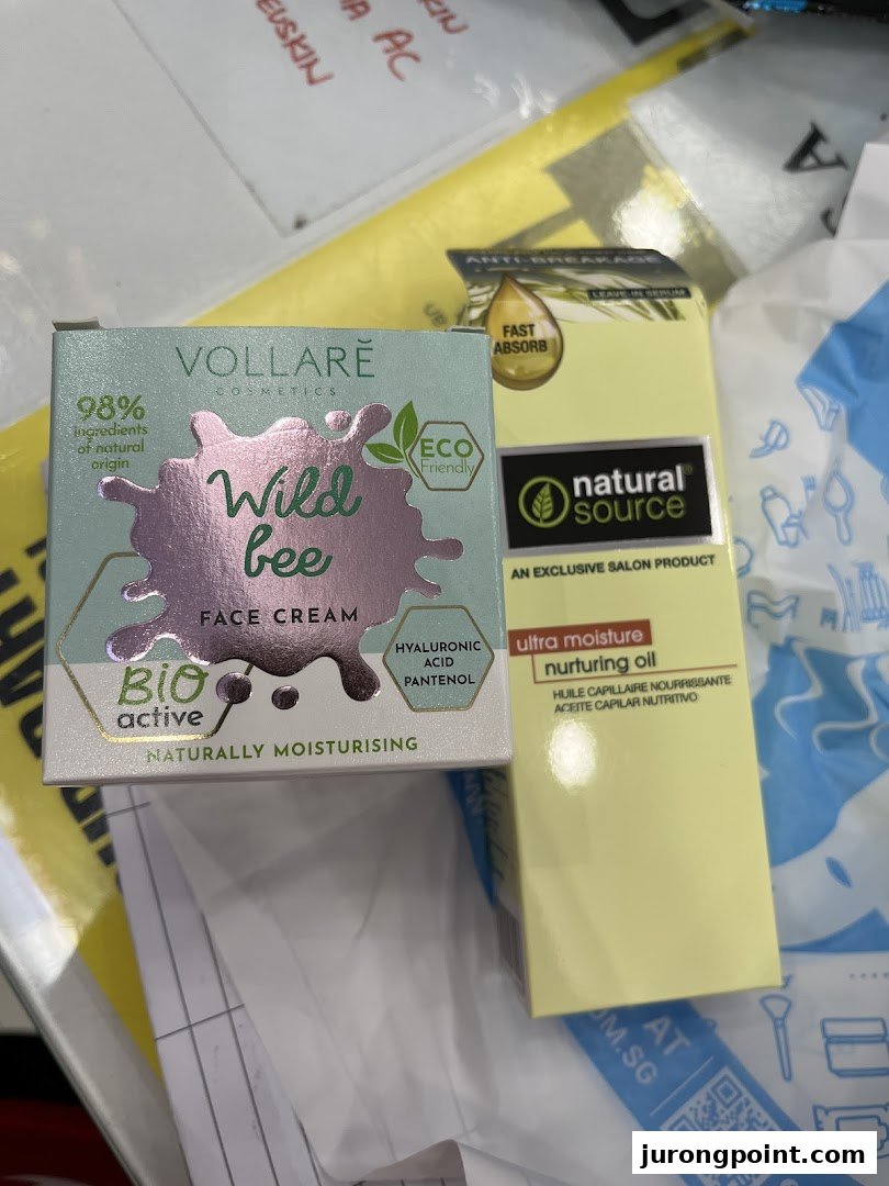 Two beauty products, Vollare Wild Bee Face Cream and Natural Source Nurturing Oil, on a surface.