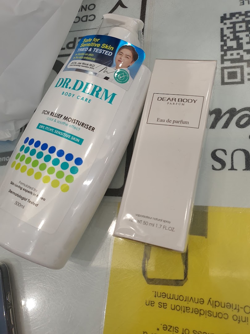 Two beauty products, Dr. Derm body moisturizer and Dear Body perfume, displayed on a surface.
