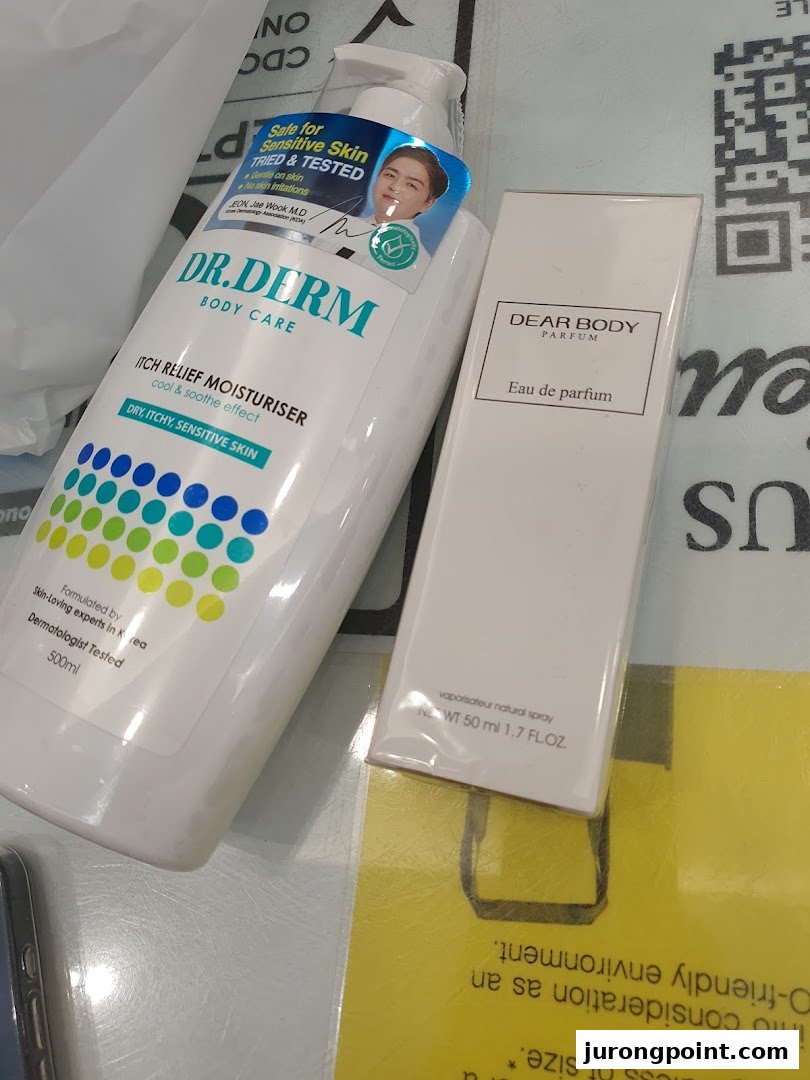 Two beauty products, Dr. Derm body moisturizer and Dear Body perfume, displayed on a surface.
