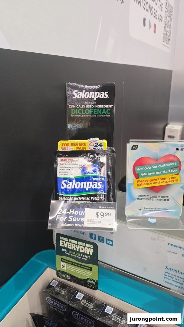 An in-store display at Watsons featuring pain relief patches, personal care items, and customer service signage.