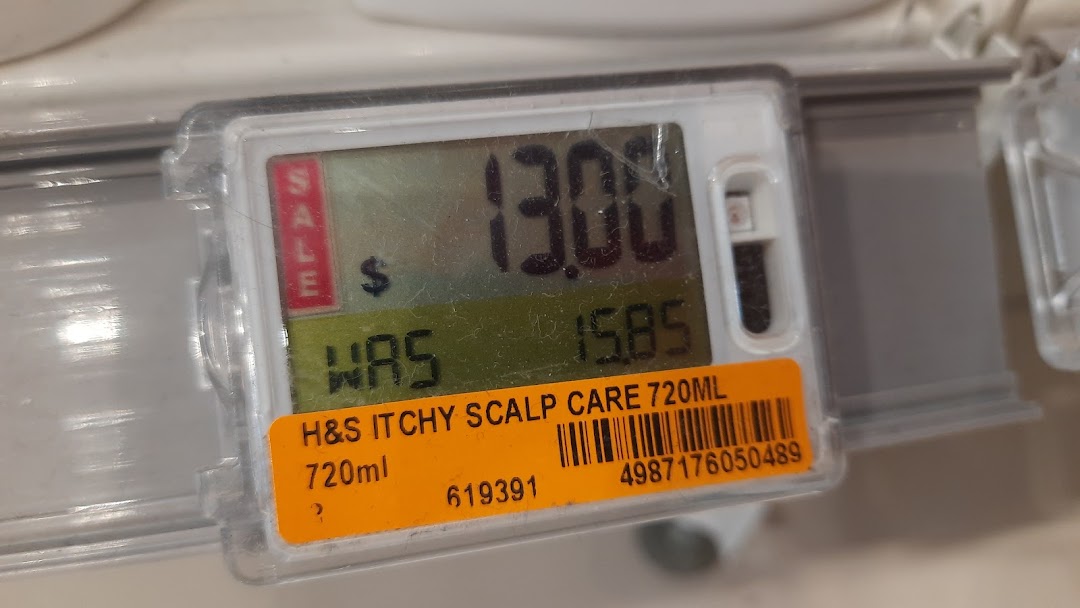 A close-up of a digital price tag showing a sale price for H&S Itchy Scalp Care 720ml.
