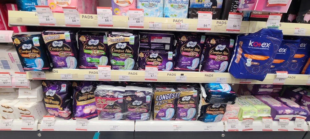 A retail shelf display featuring various feminine hygiene products, primarily sanitary pads from brands like Sofy and Kotex.