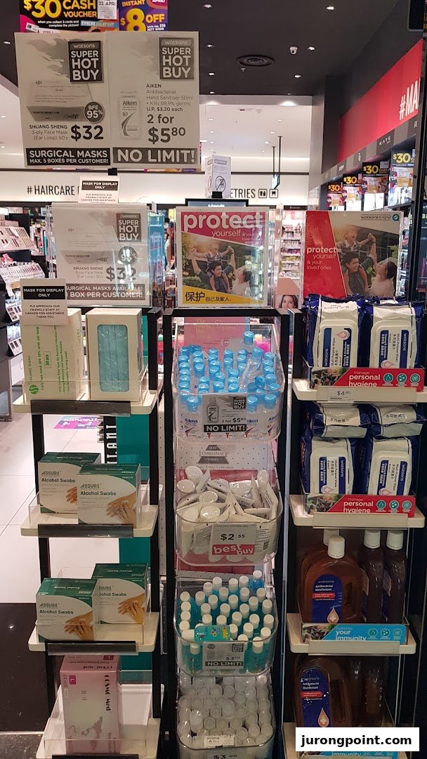 A Watsons store display featuring health and hygiene essentials like masks, hand sanitizers, and alcohol swabs.