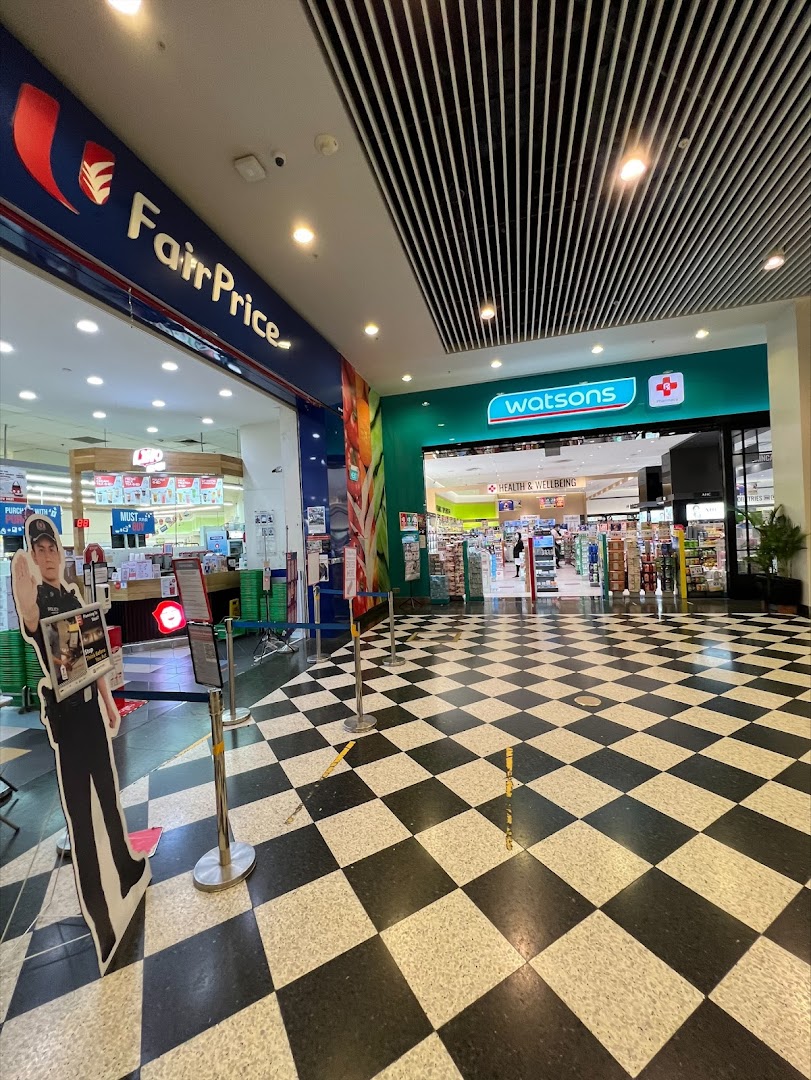 Entrance to Watsons pharmacy and FairPrice supermarket from a mall corridor with a checkered floor.