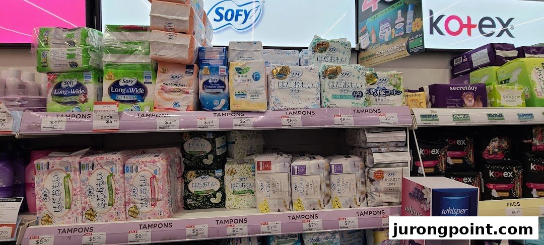 A well-stocked retail shelf inside Watsons, featuring a wide array of feminine hygiene products and personal care items.