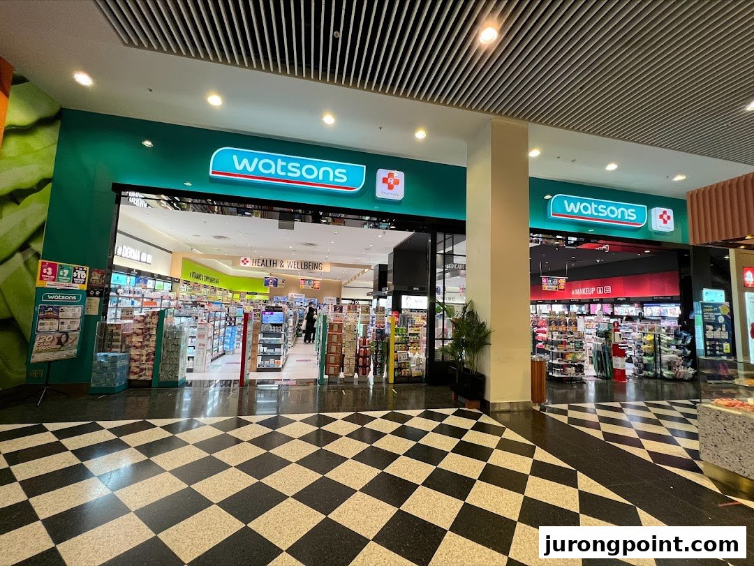 The vibrant green facade of Watsons pharmacy and health store entrance at Jurong Point.