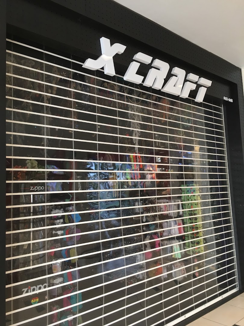 The closed storefront of X-Craft, featuring its prominent white logo and a security shutter.