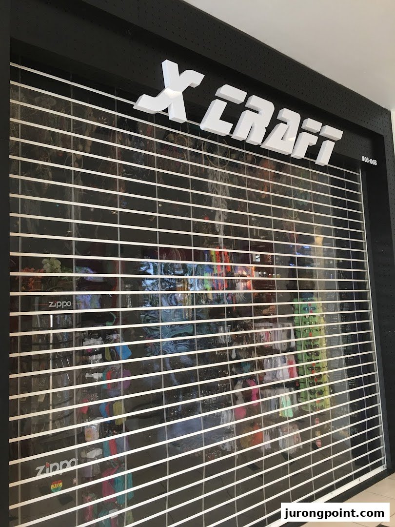 The closed storefront of X-Craft, featuring its prominent white logo and a security shutter.