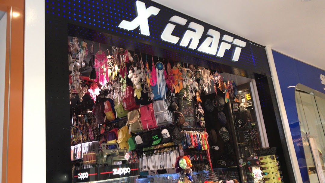 The X-Craft shop front displays a wide array of accessories, bags, and dreamcatchers.