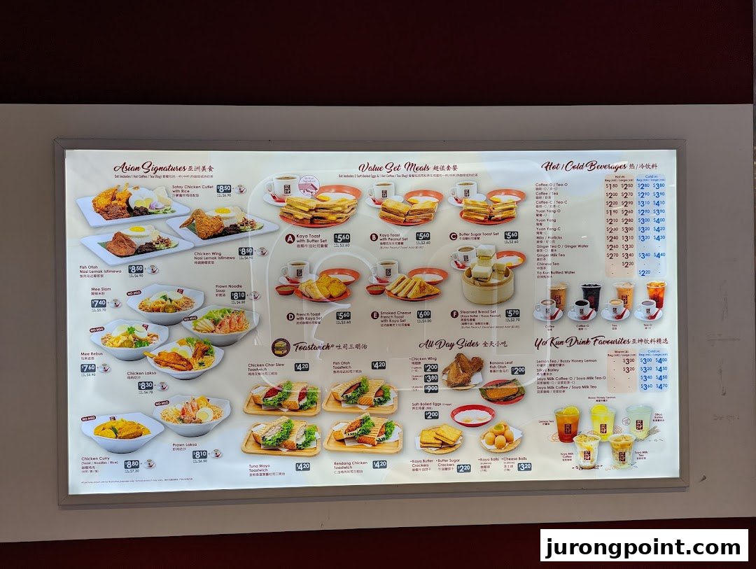 A brightly lit menu board displaying a variety of Asian signature dishes, value sets, beverages, and sides.
