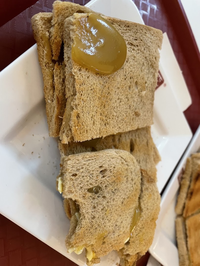 Close-up of traditional kaya toast with butter and coconut jam, a classic Singaporean breakfast item.