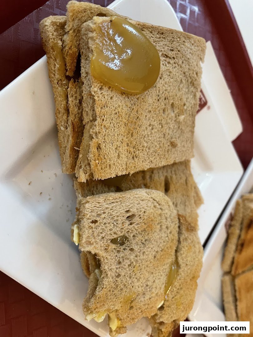 Close-up of traditional kaya toast with butter and coconut jam, a classic Singaporean breakfast item.