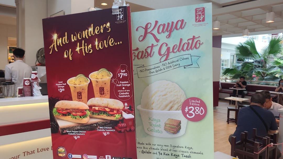 Promotional posters at Ya Kun Family Cafe showcasing new drinks, ciabatta toastwiches, and Kaya Toast Gelato.
