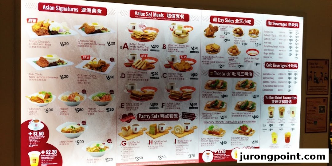 A brightly lit menu board displaying a wide array of Asian signatures, toast sets, sides, and beverages.