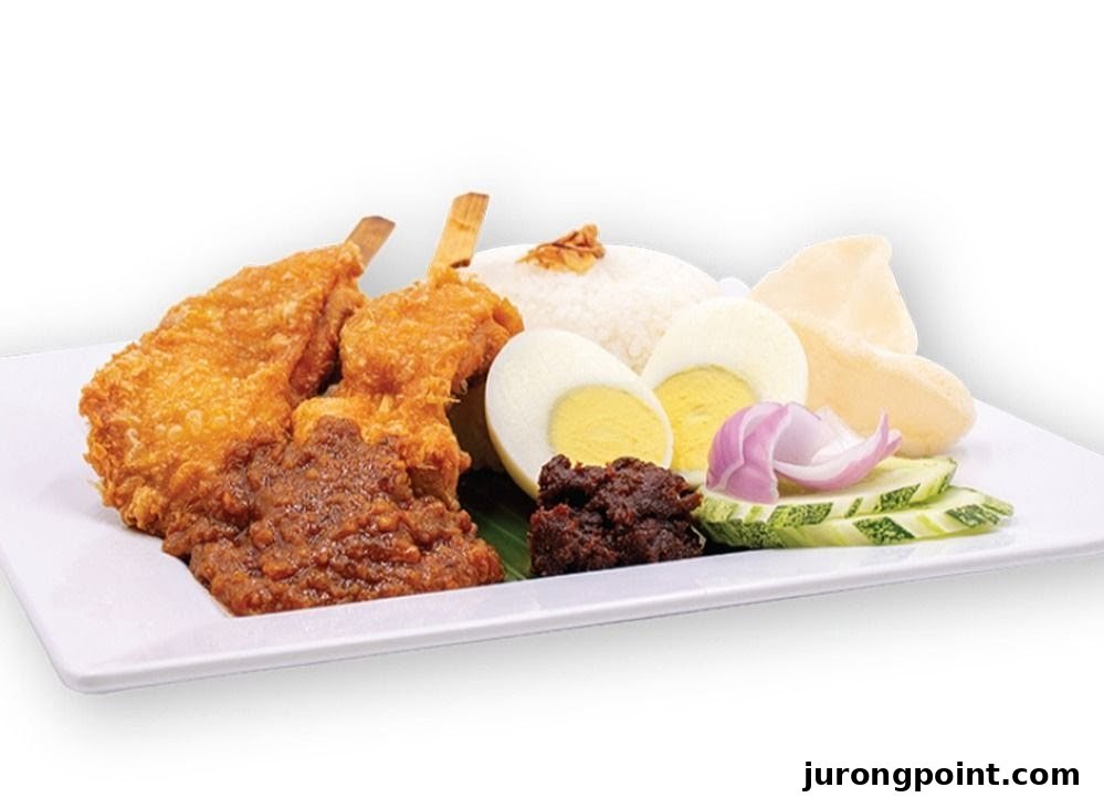 A plate of Nasi Lemak with fried chicken, fragrant rice, boiled egg, sambal, and fresh garnishes.