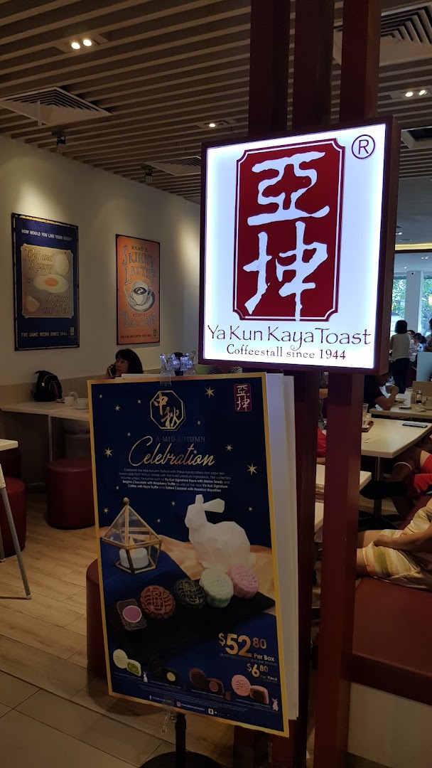 Interior view of Ya Kun Kaya Toast, featuring its iconic sign and a Mid-Autumn mooncake promotion.