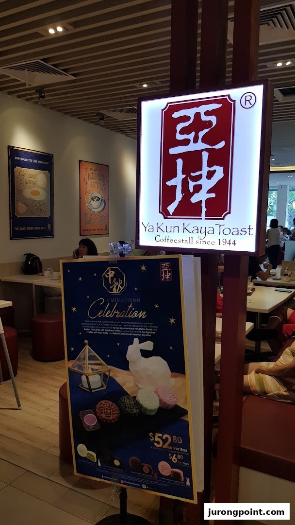 Interior view of Ya Kun Kaya Toast, featuring its iconic sign and a Mid-Autumn mooncake promotion.