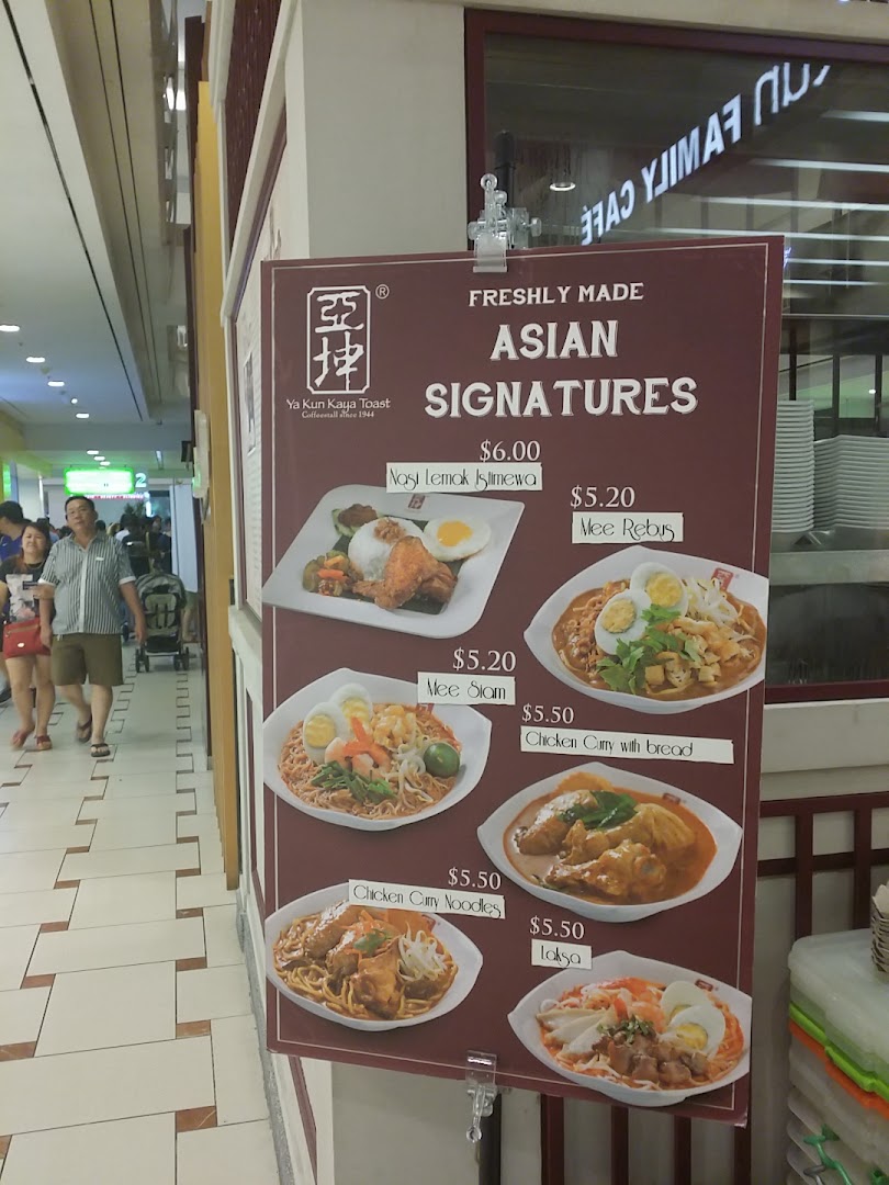 A display board showcases Ya Kun Family Cafe's freshly made Asian signature dishes with prices.