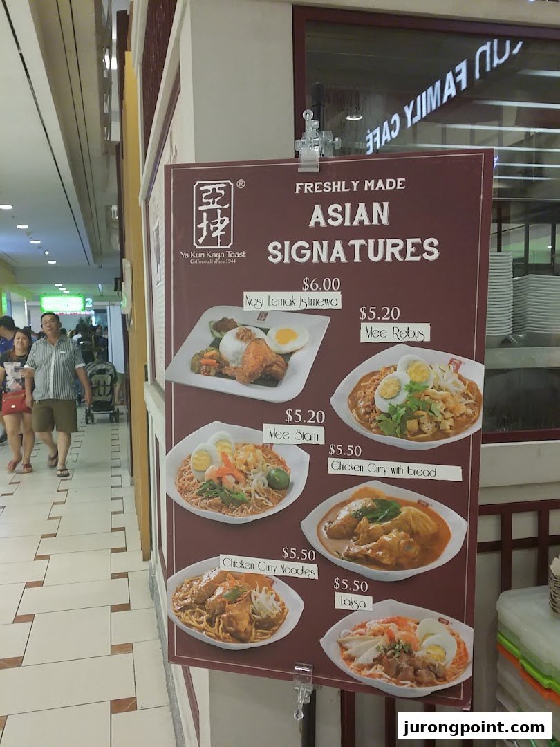 A display board showcases Ya Kun Family Cafe's freshly made Asian signature dishes with prices.