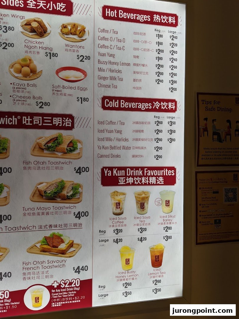 A brightly lit menu board displaying a variety of food and beverage options from Ya Kun Family Cafe.