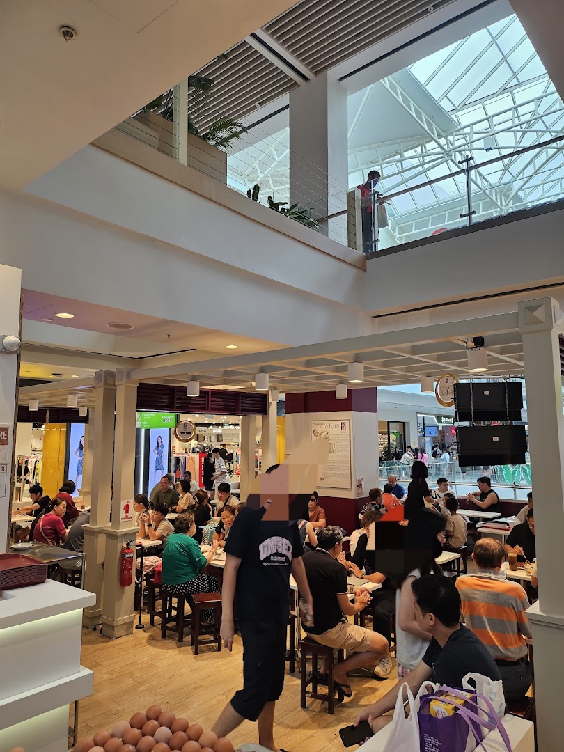 A bustling Ya Kun Family Cafe interior filled with customers enjoying their meals in a mall setting.